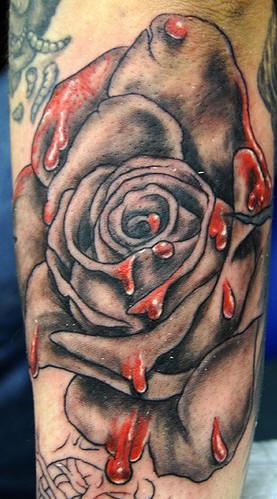 Realistic rose with blood on it tattoo