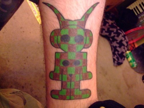 Alien female in green and red squares tattoo