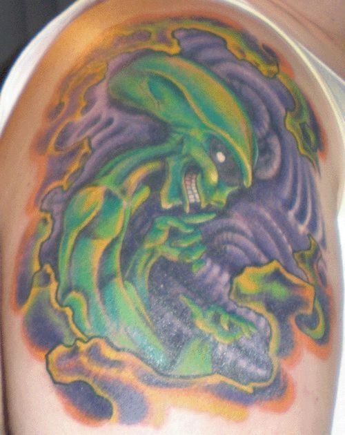 Green alien and xenomorph child coloured tattoo