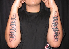 Ambigram tattoo on both forearms