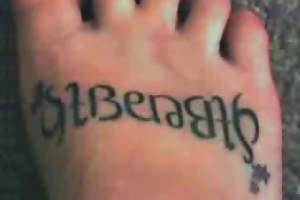 Ambigram tattoo on feet