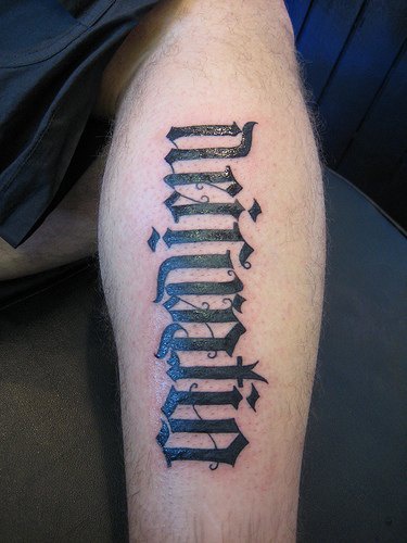 Strange ambigram word tattoo on foot