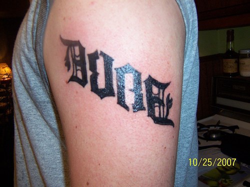Ambigram tattoo on shoulder