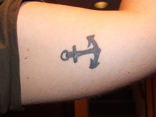 Small anchor tattoo on pathetic biceps