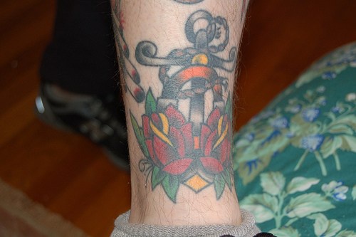 Anchor with roses coloured tattoo