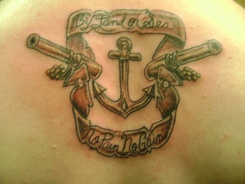 Guns and anchor tattoo with writings