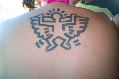 Minimalistic tribal angel tattoo on back