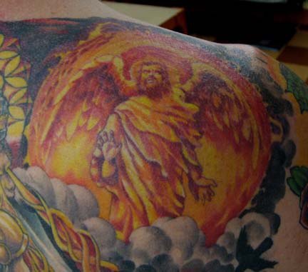 Colourful gentle archangel tattoo on shoulder