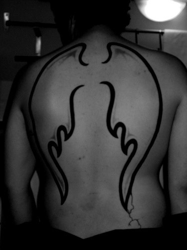 Angel wing adumbration tattoo om back