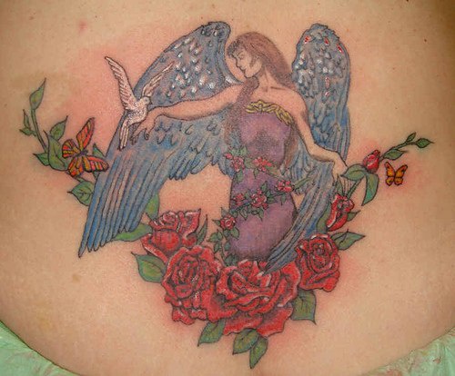 Female angel holding dove in roses tattoo