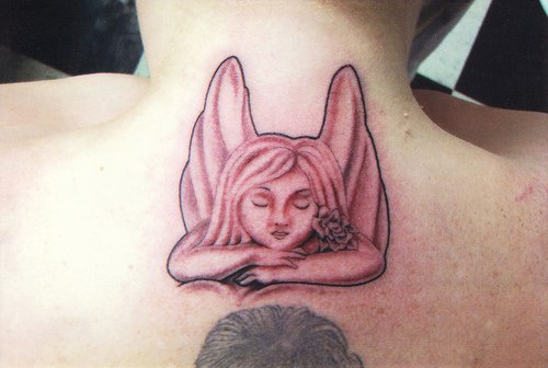 Thoughtful cherub tattoo on neck