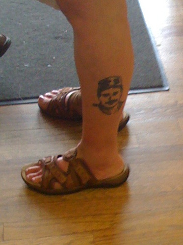 Man's portrait ankle tattoo