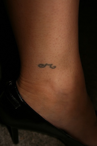 Little sign ankle tattoo