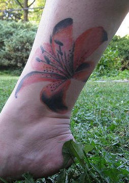 Red orchid ankle tattoo
