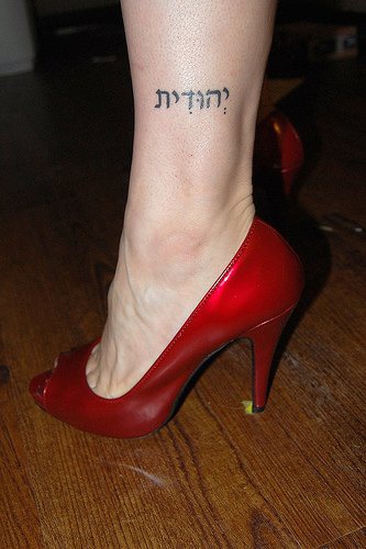 Foreign inscription ankle tattoo