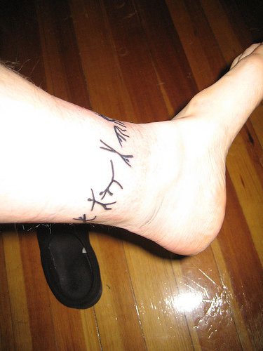 Dancing people ankle tattoo