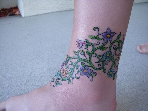 Plant with violet flowers ankle tattoo