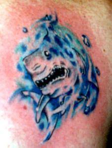 Blue tattoo with shark in the water