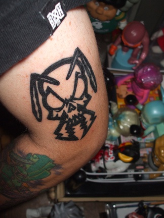 Skull with horns arm tattoo