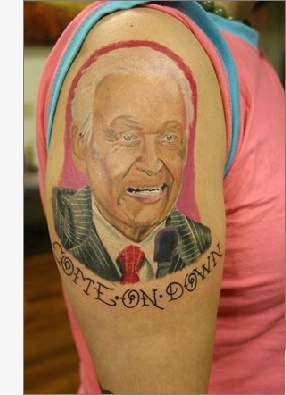 Man's portrait arm tattoo