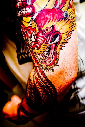 Tattoo von Drache am Arm