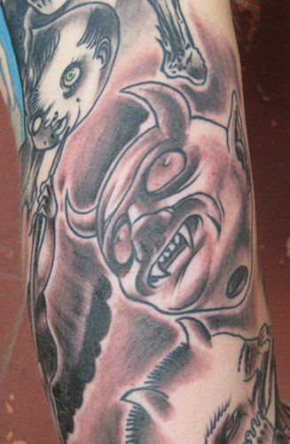Horned evil arm tattoo