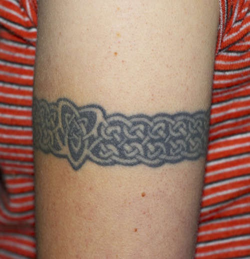 Celtic tracery on arm band tattoo
