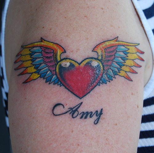 Heart with wings arm sleeve tattoo