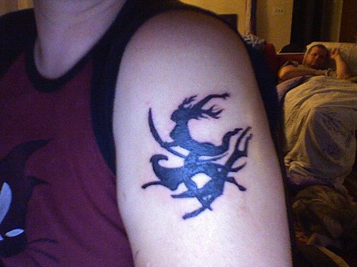 Black deer arm tattoo