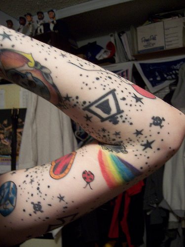 Black and coloured things arm tattoo