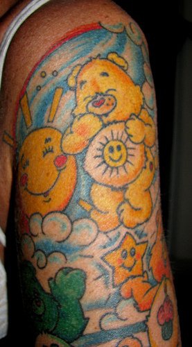 Cartoon bear arm tattoo