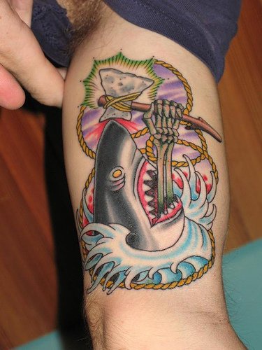 Skull in shark&quots mouth arm tattoo