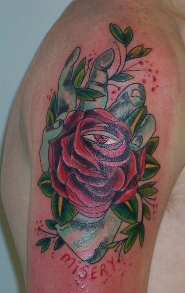 Oil avec une rose le tatouage sur le bras
