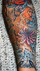 Koi fish in sea waves sleeve tattoo in colour