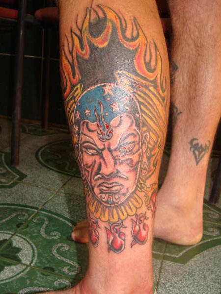 Aztec shaman in flames coloured tattoo