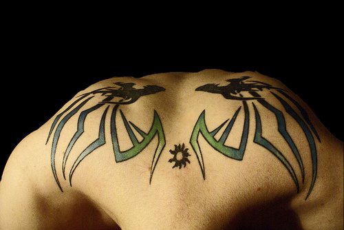 Two  similar monsters on upper back styled tattoo