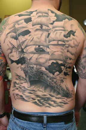 Giant ship on upper back tattoo in stormy sea