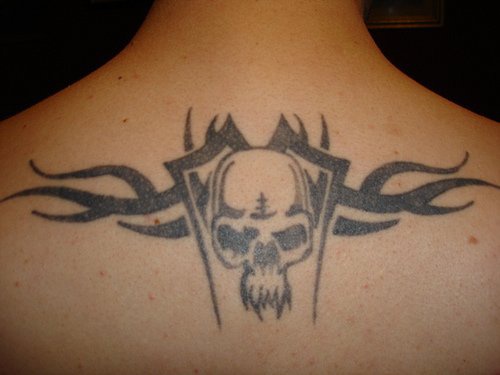 Evil skull tattoo styled on upper back