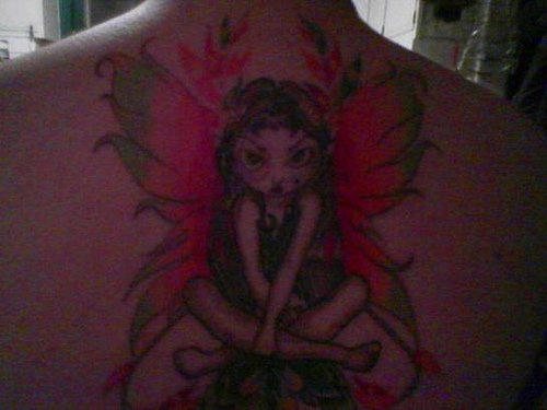 Tatuaggio ameno sulla schiena la fata triste e arrabbiata con le ali