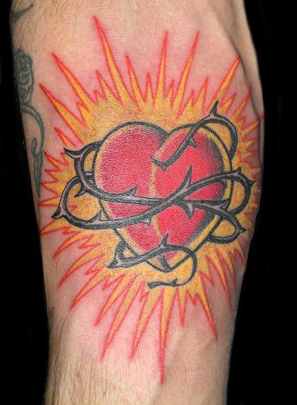 Heart in barb wire colourful tattoo