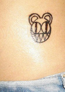 Minimalistic cartoonish bear tattoo