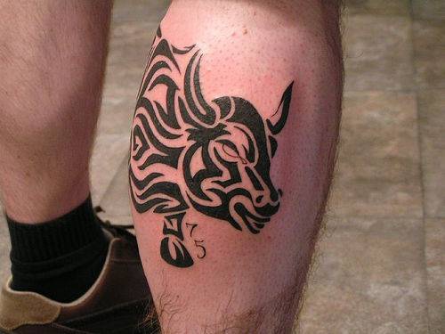 Tribal bull tattoo on leg