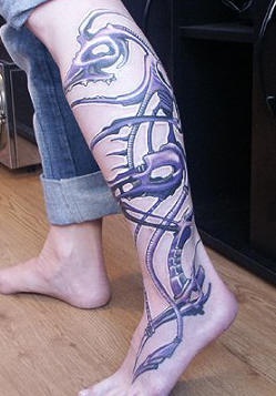 Biomech tracery tattoo on leg