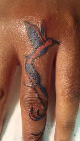 Blue bird on finger tattoo