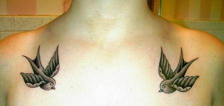 Tatuaggio sulle clavicole due uccelli neri