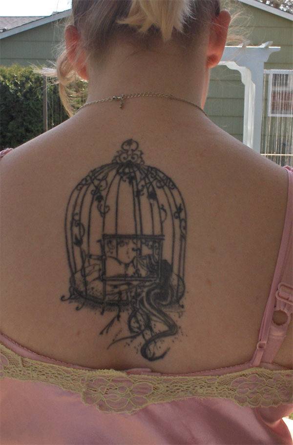 Bird cage tattoo on back