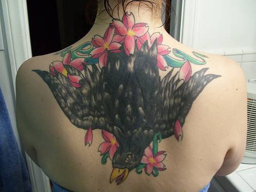 Black raven in flowers on back