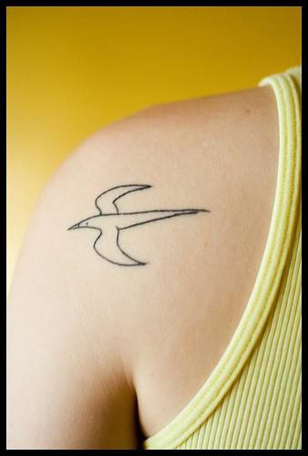 Tatuaggio piccolo sulla spalla il disegno nero in forma dell&quotuccello