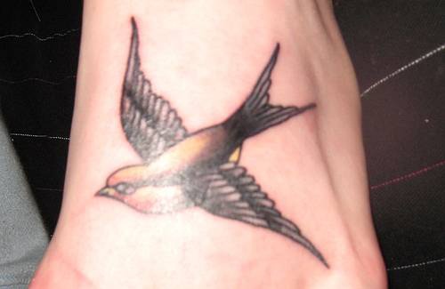 Flying black sparrow tattoo
