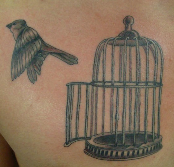 Bird flying out of bird cage tattoo